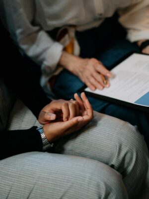 Two professionals reviewing a resume in an office setting, focused on teamwork.
